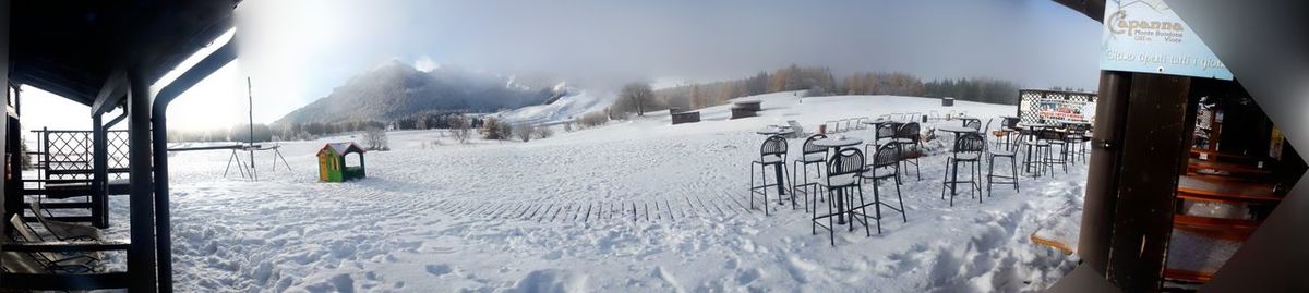 Snow covered landscape against sky