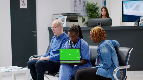 Young woman using laptop while sitting in office