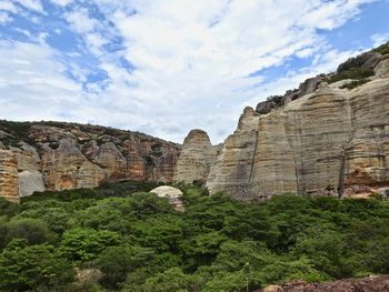 View of cliff against cloudy sky