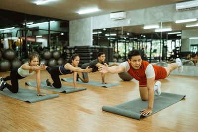 Side view of woman exercising in gym