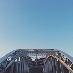 Low angle view of bridge against clear blue sky