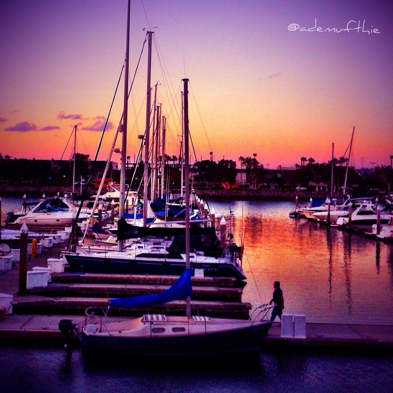 nautical vessel, moored, boat, transportation, water, mode of transport, mast, sunset, harbor, sailboat, sea, marina, reflection, sky, waterfront, orange color, silhouette, travel, dusk, nature