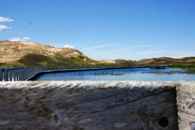 Scenic view of river against blue sky