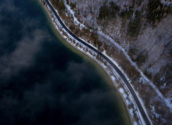High angle view of road amidst trees against sky