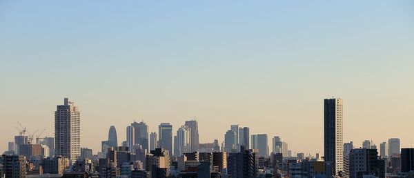 Modern cityscape against clear sky