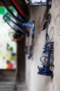 Close-up of electric lamp hanging on wall