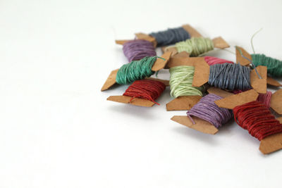 Close-up of colored pencils over white background