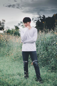 Full length of young man standing on field