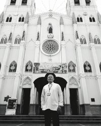 Portrait of young man standing against temple