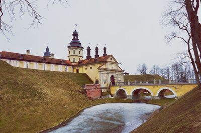 Arch bridge by building against sky during winter