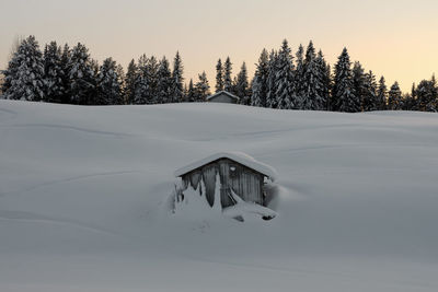 Scenic view of snowcapped landscape against sky during winter