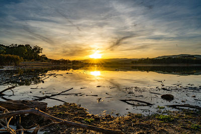 Scenic view of lake against sky during sunset