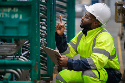 Rear view of construction worker standing in factory