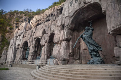 Low angle view of statue against temple