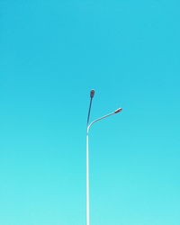 Low angle view of street light against clear blue sky