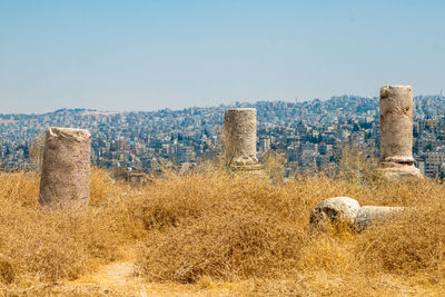 Old ruin on field against clear blue sky