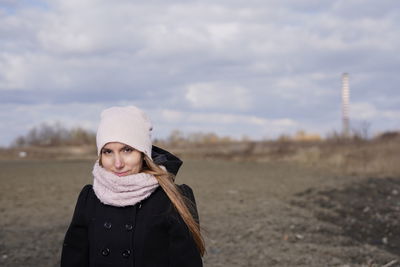 Portrait of young woman standing in snow