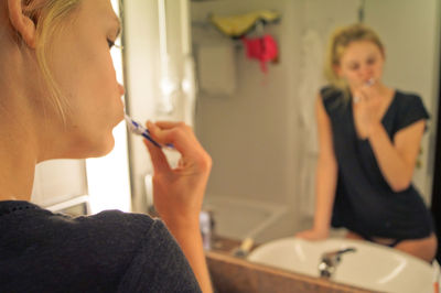 Close-up of woman brushing teeth