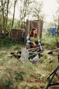 Portrait of woman sitting on field