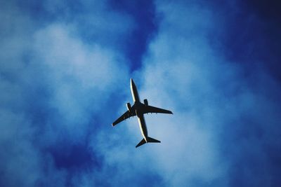 Low angle view of airplane flying in sky