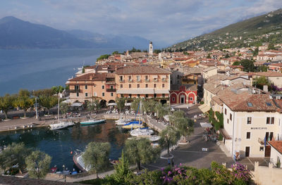 High angle view of townscape by sea against sky