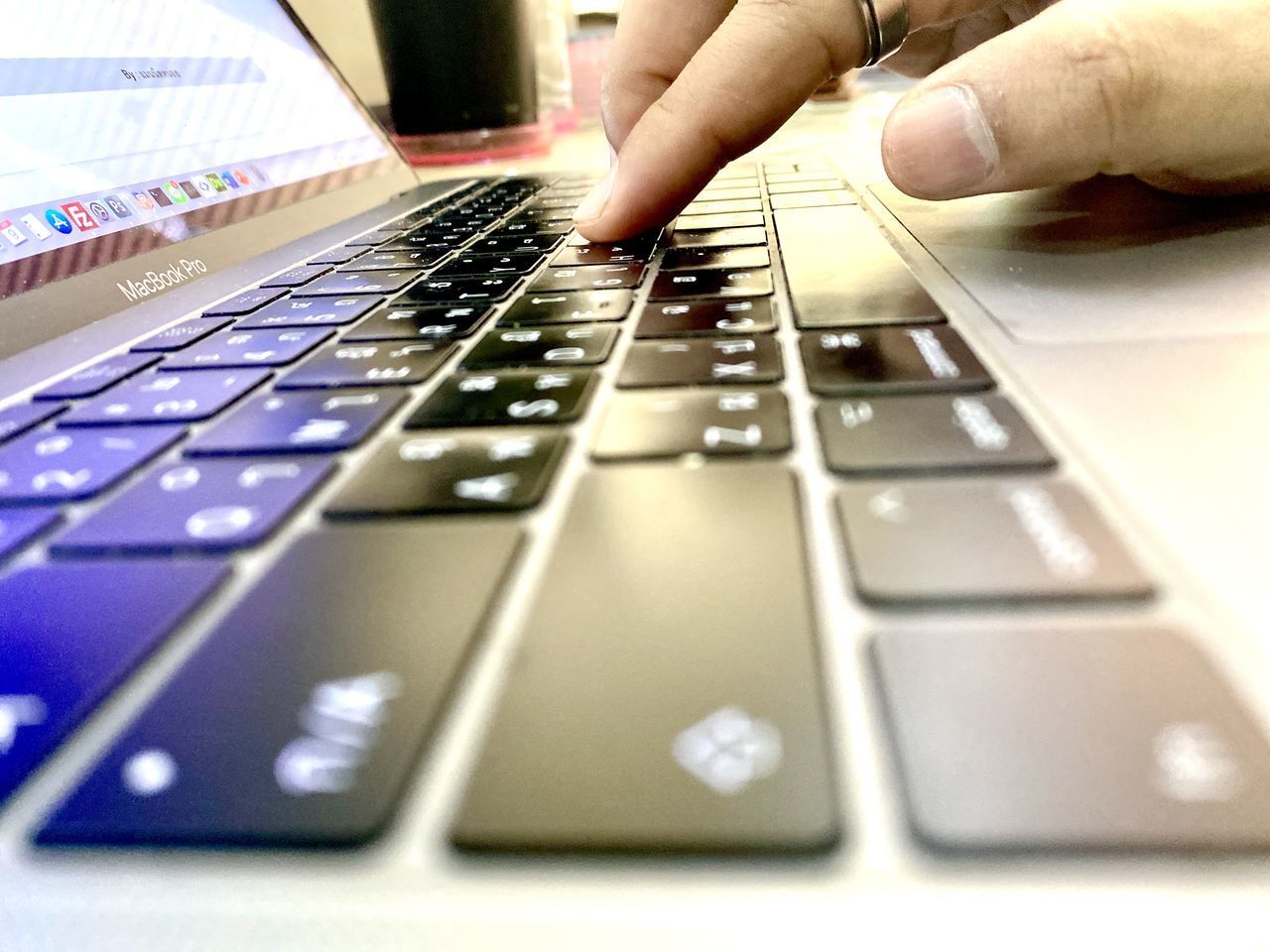 CLOSE-UP OF PERSON USING MOBILE PHONE IN LAPTOP