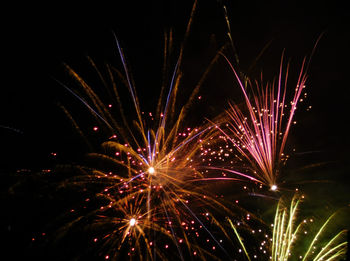 Low angle view of firework display at night