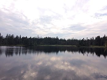 Scenic view of lake against sky at sunset