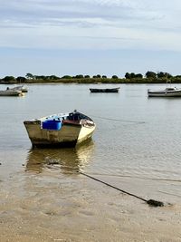 Boats in sea against sky