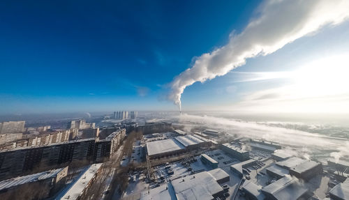 Smoke emitting from chimney against sky