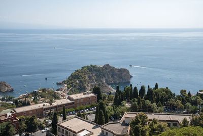 High angle view of coastal city in island by mediterranean sea during summer