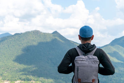 Man standing on mountain against sky