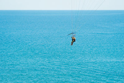 Man surfing in sea against sky