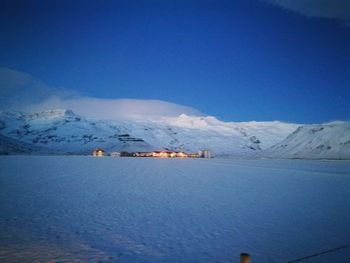 Scenic view of snow mountains against blue sky