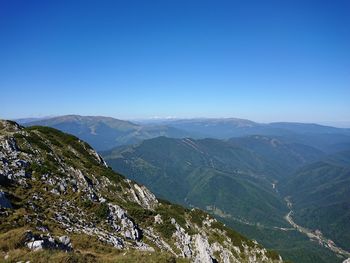 Scenic view of mountains against clear blue sky