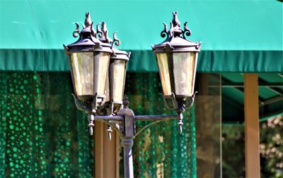 Close-up of lamp post against house