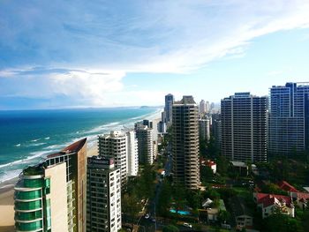 View of cityscape against cloudy sky