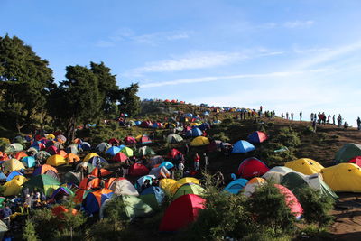 High angle view of multi colored tents on field against sky