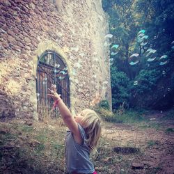 Girl playing with bubbles on field