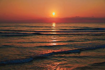 Scenic view of sea against romantic sky at sunset