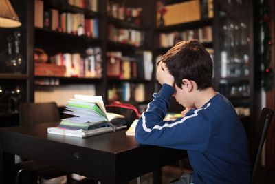 Boy sitting on book