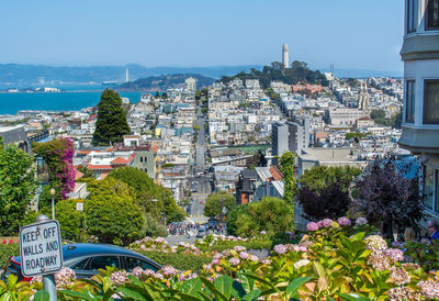 View of city by sea against clear sky