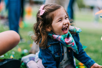 Close-up of cute girl smiling outdoors