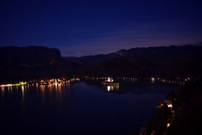 Scenic view of lake against sky at night