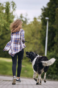 Rear view of woman with dog