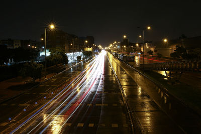 Light trails on road in city at night