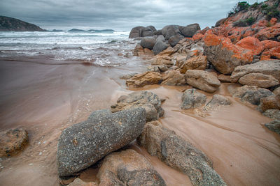 Rocks in sea against sky