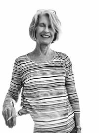 Portrait of smiling woman standing against white background