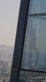 Reflection of man on glass window