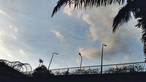 Low angle view of silhouette tree against cloudy sky